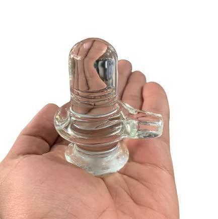 Handheld Sphatik Shivling, 4-inch crystal decorative showpiece for home pooja, showcasing its compact size and clarity.