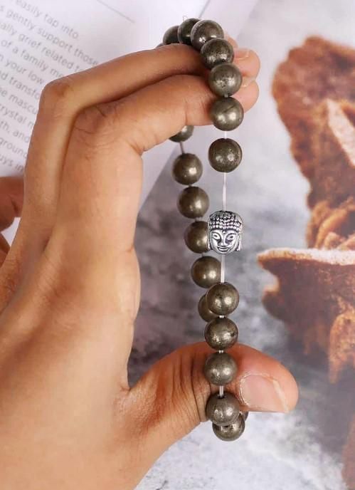 Unisex Pyrite elastic bracelet with a silver Buddha lucky charm. Stylish and casual, this stone bracelet offers spiritual benefits for men and women.