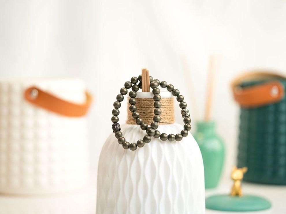 Unisex Pyrite elastic bracelet with a lucky charm, featuring natural stone beads. Stylish and casual accessory offering pyrite stone benefits.