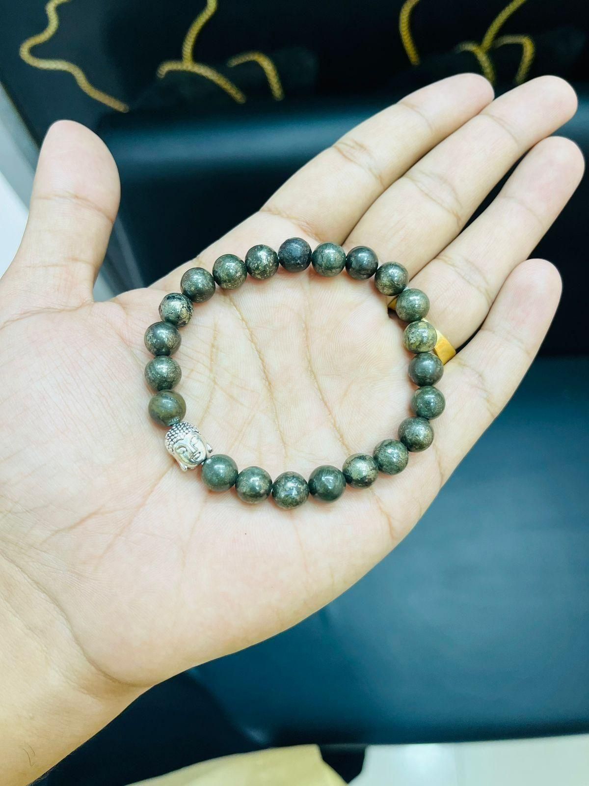 Unisex Pyrite elastic bracelet with a lucky charm, featuring natural stone beads. Ideal for casual wear, offering style and potential stone benefits.